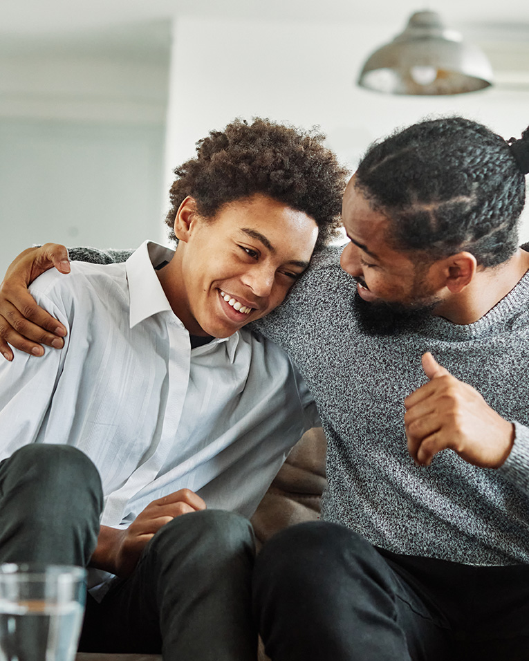 Black father and son joking together; Therapy for Teens