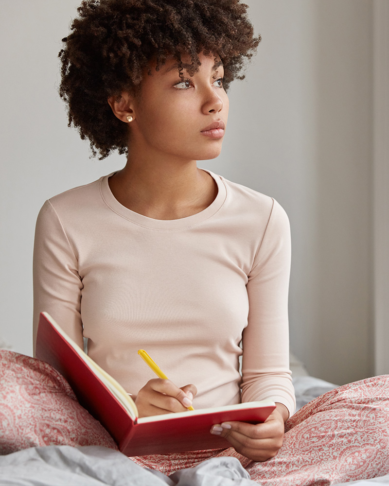 Teenager with a journal in need of therapy for teens