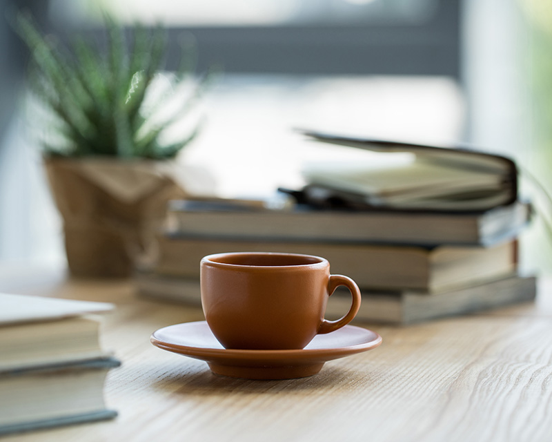 Stack of books and a cup of coffee